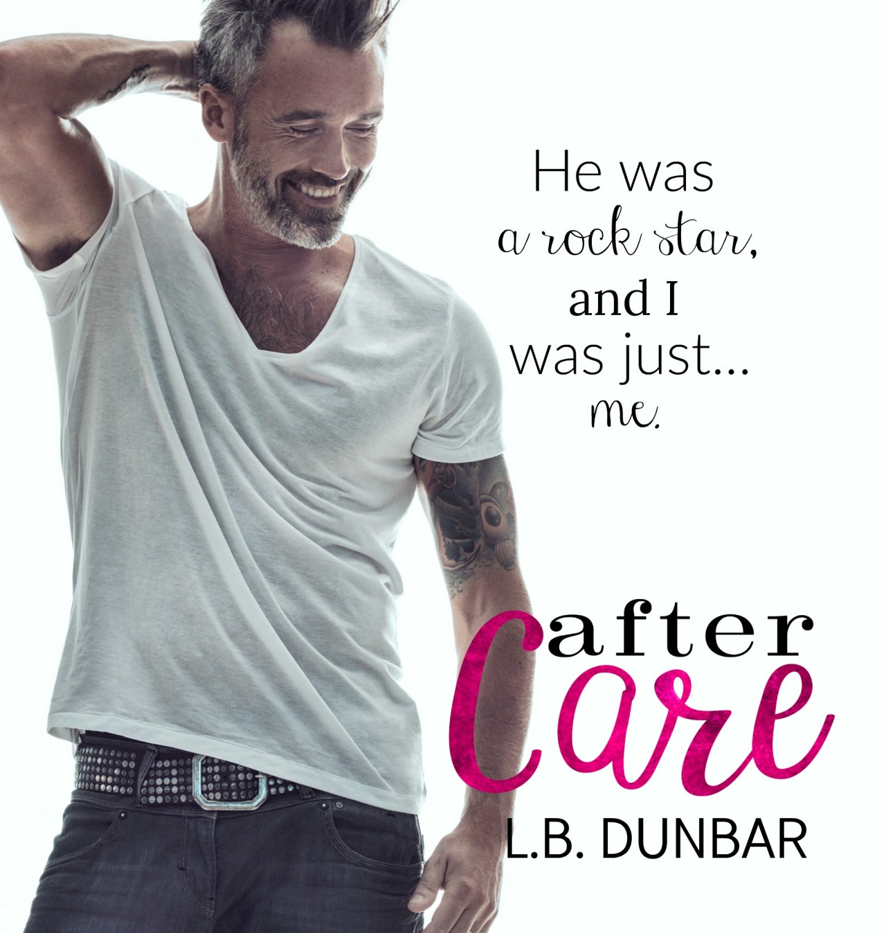 A mature bearded man with tattoos standing against a white background