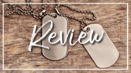 Dog tags on wood, close up. Top view, flat lay. Wooden desk surface background.